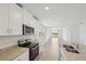 Modern kitchen featuring an island, granite countertops, and white cabinets at 165 Lazy Shore Dr, Nokomis, FL 34275