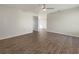 Open living area with wood-look floors and access to other rooms at 8381 Chelsea Ct, North Port, FL 34287