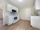Clean kitchen with white cabinets, new appliances, and wood-look floors at 8381 Chelsea Ct, North Port, FL 34287