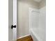 Clean bathroom with a shower/tub combo and wood-look floors at 8381 Chelsea Ct, North Port, FL 34287