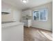 Kitchen with white cabinets, quartz countertops, and wood-look floors at 8381 Chelsea Ct, North Port, FL 34287