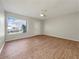 Bright living room with wood-look floors and view of front yard at 8381 Chelsea Ct, North Port, FL 34287