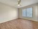 Well-lit bedroom featuring wood-look floors and a large window at 8381 Chelsea Ct, North Port, FL 34287