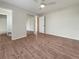 Bright bedroom featuring wood-look floors and mirrored closet doors at 8381 Chelsea Ct, North Port, FL 34287