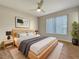 Spacious bedroom with wood-look floors, ceiling fan and large window at 8381 Chelsea Ct, North Port, FL 34287