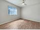 Well-lit bedroom with wood-look floors and window with blinds at 8381 Chelsea Ct, North Port, FL 34287