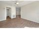 Spacious living room with wood-look floors and access to other rooms at 8381 Chelsea Ct, North Port, FL 34287