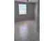 Bedroom with tile floors and single window at 3023 W Green St, Tampa, FL 33607