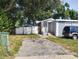 House exterior with a driveway and a yard at 3023 W Green St, Tampa, FL 33607
