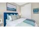 Bedroom with blue velvet headboard and ocean-themed art at 16123 Culpepper Dr, Bradenton, FL 34211