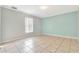 Light and airy bedroom with tile floors and two-toned walls at 2443 Waterfall Dr, Spring Hill, FL 34608