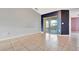 Open living room with tile floors and access to patio at 2443 Waterfall Dr, Spring Hill, FL 34608