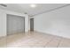 Empty bedroom with gray doors and tile floors at 2443 Waterfall Dr, Spring Hill, FL 34608