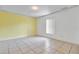 Simple bedroom with light yellow walls and tile floors at 2443 Waterfall Dr, Spring Hill, FL 34608