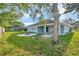 Large backyard with firepit and covered patio at 2443 Waterfall Dr, Spring Hill, FL 34608