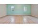 Large living room featuring tile floors and two windows at 2443 Waterfall Dr, Spring Hill, FL 34608