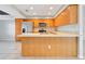 Spacious kitchen featuring wood cabinets, stainless steel appliances, and an island at 2443 Waterfall Dr, Spring Hill, FL 34608