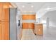 Modern kitchen boasting stainless steel appliances and wood cabinetry at 2443 Waterfall Dr, Spring Hill, FL 34608