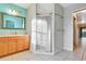 Bathroom with wood cabinets, a shower, and a mirrored medicine cabinet at 2443 Waterfall Dr, Spring Hill, FL 34608