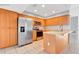 Kitchen with stainless steel appliances and light wood cabinets at 2443 Waterfall Dr, Spring Hill, FL 34608