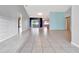 Living room showcasing tile floors and access to exterior at 2443 Waterfall Dr, Spring Hill, FL 34608