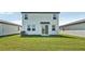 View of the home's backyard featuring a well-maintained lawn and patio at 14044 Crutchfield Ct, Parrish, FL 34219