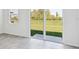 Bright, open room with slider doors showcasing the green backyard, tile floors, and modern design at 14044 Crutchfield Ct, Parrish, FL 34219