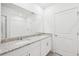 Bathroom featuring a double vanity with granite countertop and a large mirror at 14044 Crutchfield Ct, Parrish, FL 34219