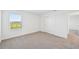 A bright bedroom with a window view, neutral carpet, and closet at 14044 Crutchfield Ct, Parrish, FL 34219