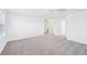 Large bedroom with neutral carpet, bright natural light, and multiple doors at 14044 Crutchfield Ct, Parrish, FL 34219