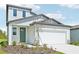 Contemporary two-story home with a two-car garage, appealing exterior finishes, and fresh landscaping at 14044 Crutchfield Ct, Parrish, FL 34219