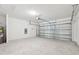 Spacious two-car garage with an automatic door opener and concrete flooring at 14044 Crutchfield Ct, Parrish, FL 34219