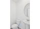 Clean half bathroom with pedestal sink, round mirror and tile floors at 14044 Crutchfield Ct, Parrish, FL 34219
