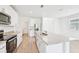 Well-equipped kitchen with stainless steel appliances, white cabinets, granite countertops, and a kitchen island at 14044 Crutchfield Ct, Parrish, FL 34219