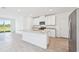 Spacious kitchen with stainless steel appliances, white cabinets, granite countertops, and an island at 14044 Crutchfield Ct, Parrish, FL 34219