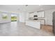 Bright open-concept living space with tile flooring, recessed lighting, and a kitchen island at 14044 Crutchfield Ct, Parrish, FL 34219