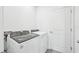 Convenient laundry room features a modern Whirlpool washer and dryer at 14044 Crutchfield Ct, Parrish, FL 34219
