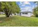 Ranch style home with a spacious front yard and mature landscaping at 1845 Skyland Dr, Clearwater, FL 33759