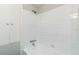 Clean bathroom with white tiled walls, bathtub, and linen closet at 1845 Skyland Dr, Clearwater, FL 33759