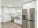 Modern kitchen with white cabinets, stainless steel appliances and farmhouse sink at 1845 Skyland Dr, Clearwater, FL 33759