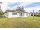 Single story home with a spacious lawn and white exterior at 1845 Skyland Dr, Clearwater, FL 33759