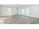 Living room with wood-look floors and large window at 1845 Skyland Dr, Clearwater, FL 33759