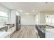 Open concept kitchen with stainless steel appliances and white cabinets at 1845 Skyland Dr, Clearwater, FL 33759