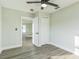 Bright bedroom featuring wood-look floors and ceiling fan at 1845 Skyland Dr, Clearwater, FL 33759