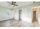 Bedroom with ceiling fan, double doors to closet, and hardwood floors at 1845 Skyland Dr, Clearwater, FL 33759