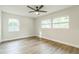 Bright bedroom with ceiling fan and two windows at 1845 Skyland Dr, Clearwater, FL 33759