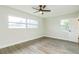Spacious bedroom with large windows and wood-look floors at 1845 Skyland Dr, Clearwater, FL 33759