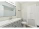 Updated bathroom with gray vanity and a tiled shower at 1845 Skyland Dr, Clearwater, FL 33759