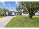 House exterior with a large tree and driveway at 1845 Skyland Dr, Clearwater, FL 33759