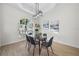 Elegant dining room with glass table and gray chairs near large window at 4320 Genesee Ln, New Port Richey, FL 34655